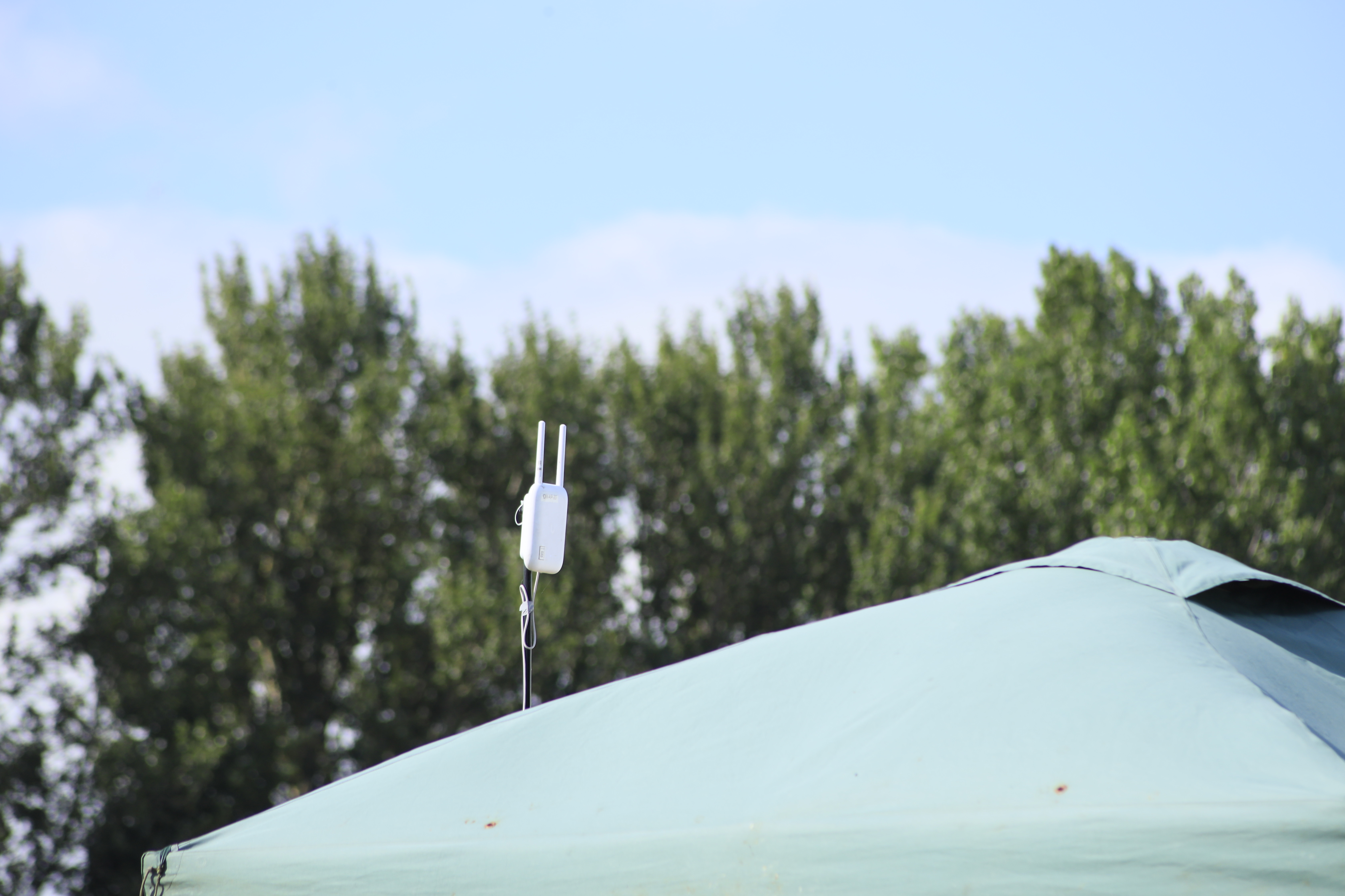 Access point rigged above a pop-up gazebo