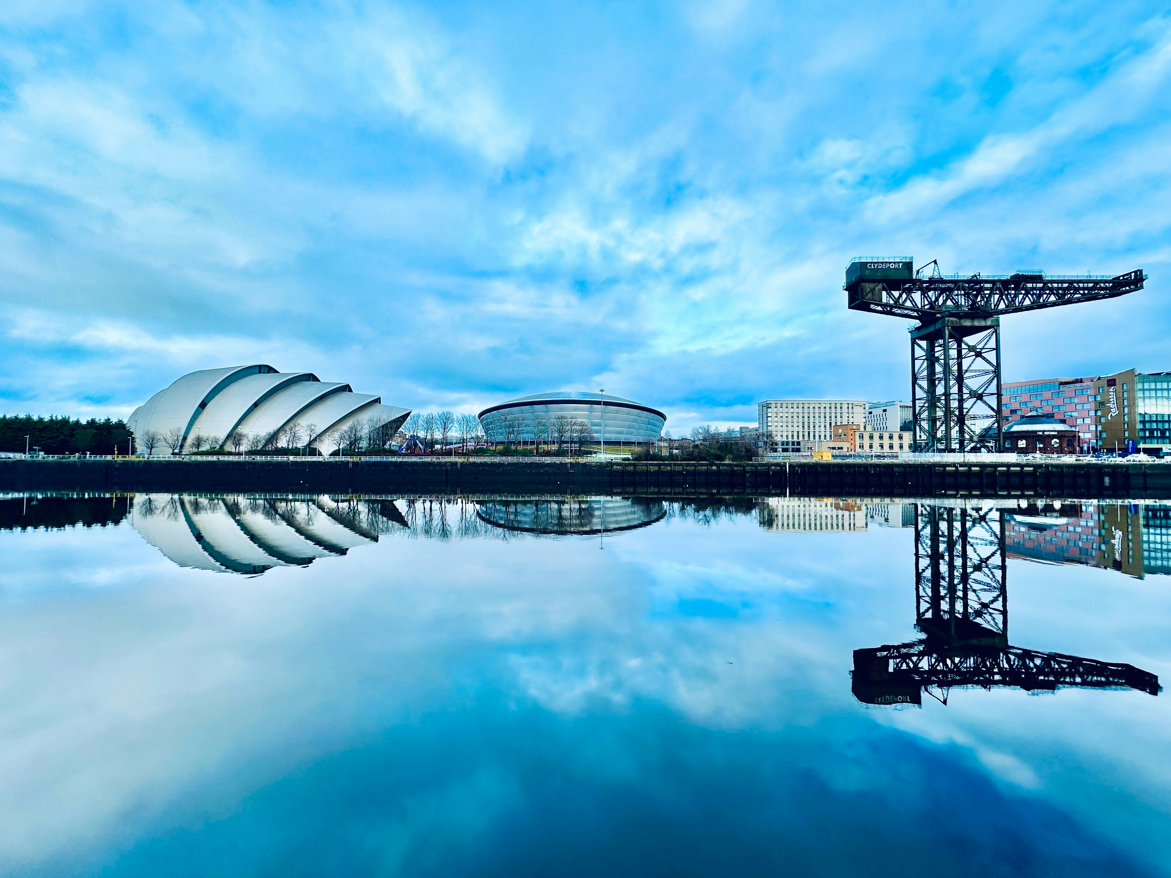 The SEC Armadillo, OVO Hydro and Finnieston Crane reflected in the River Clyde in Glasgow